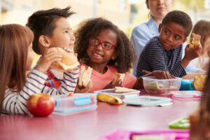 Group of kids eating at a lunch table
